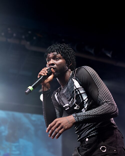 Omah Lay performing live on stage